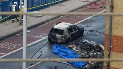 Debris and a burned out car are pictured at the scene of a helicopter crash in Vauxhall