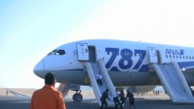 Passengers evacuating a Dreamliner aircraft in Japan