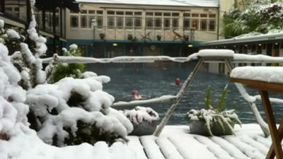 Swimming Pool (and swimmers) surrounded by snow