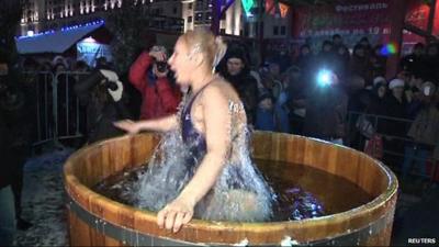 Woman jumps into ice water in barrel