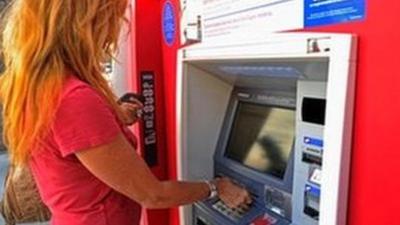 Woman at a cash machine