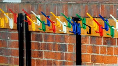 Empy coat pegs at a closed school