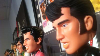 Elvis Presley dolls sitting on a shelf