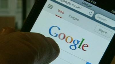 Finger pointing at Google search page on a smartphone