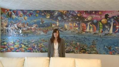 Amanda Warrington from South Gloucestershire, standing in front of her completed 24,000 jigsaw puzzle