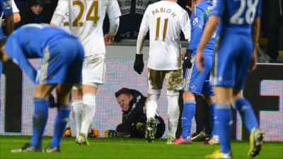 A ballboy lies on the ground after Chelsea's Eden Hazard had kicked out at him