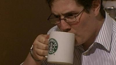 Man drinking from Starbucks mug