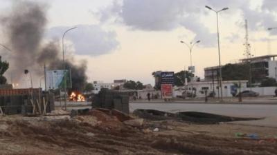 Police car burns after clashes in Benghazi in December 2012