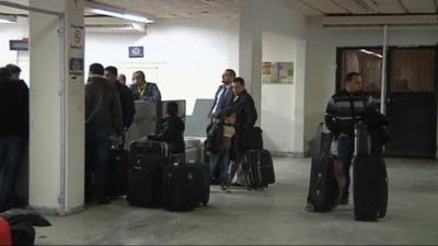 People with suitcases at Benghazi airport