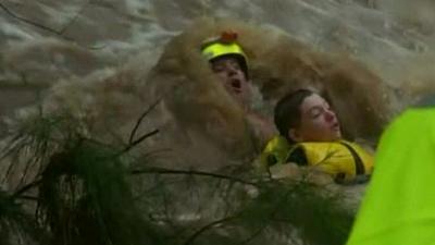 Teenager being rescued from floodwaters in Queensland