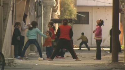Children play in street in Homs