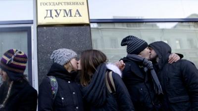 Gay rights campaigners kiss each other during a protest outside of State Duma, Russian Parliament