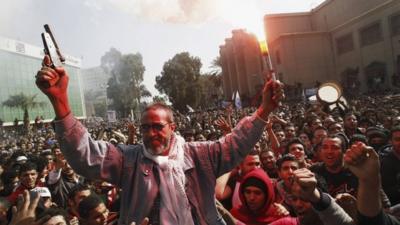 The father of an al-Ahly fan who died celebrates with soccer fans