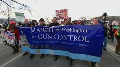 People with banners at the gun control rally