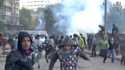 Demonstrators run away from teargas