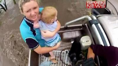 Helicopter footage shows toddler being rescued from Queensland floods