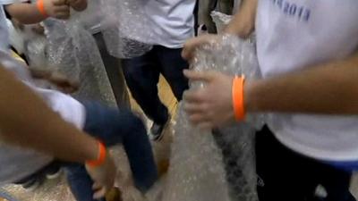 Students popping bubble wrap