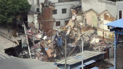 Several buildings collapsed inside the hole in Guangzhou