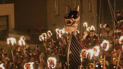 A replica Viking longboat is paraded through the streets