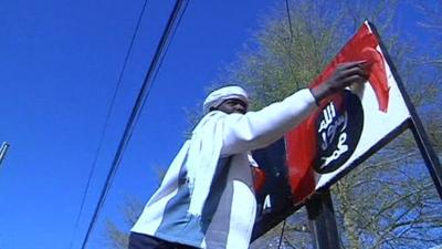 Malian painting over an Islamic Police sign