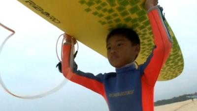 Boy with surfboard
