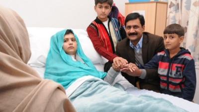 Malala Yousafzai surrounded by family