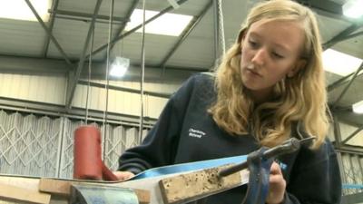 Teenage girl doing manufacturing apprenticeship