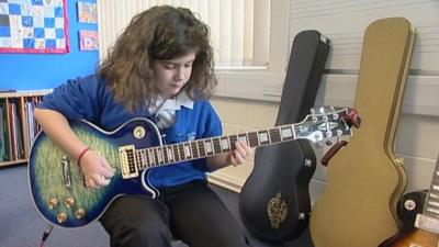 Ayla playing the guitar