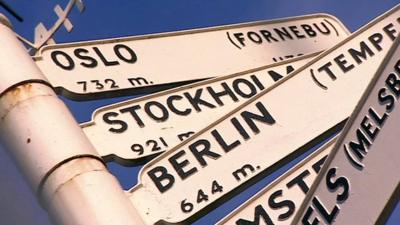 A sign displaying the distances to international cities