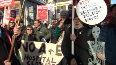 Protesters with banners and placards demonstrating against plans to cut services at Lewisham hospital