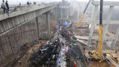 Rescuers work under the collapsed Yichang bridge near the city of Sanmenxia, central China