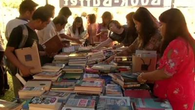 People looking at books on a table