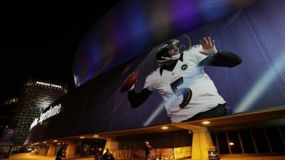 Picture of American footballer projected on to stadium in New Orleans