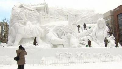 Visitors taking pictures at Sapporo Snow Festival