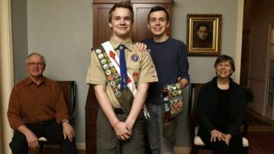 Pascal Tessier, 16, center and his brother Lucien Tessier, 20, pose for a portrait with their parents.