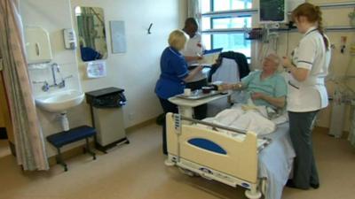 Medics around patient in hospital bed