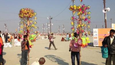 Children selling toys on bank of Sangam