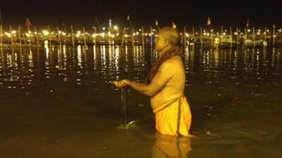 Devotee bathing in river