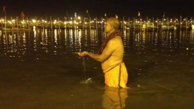 Devotee bathing in river