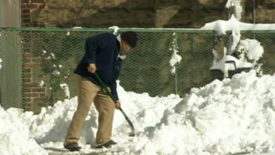 Man shovelling snow in New York