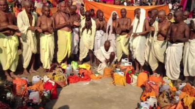 Group of men from North Indian state of Bihar praying to Ganges