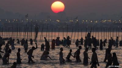 Hindu devotees bathe on the banks of Sangam