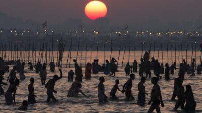 Hindu devotees bathe on the banks of Sangam