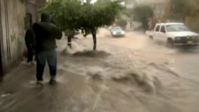 Pedestrian and car in flooded street