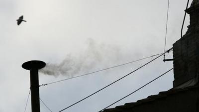 White smoke rising from the chimney above the Sistine Chapel in the Vatican indicating the election of German Cardinal Ratzinger as Pope Benedict XVI