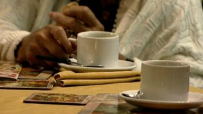 Elderly woman with tea cup