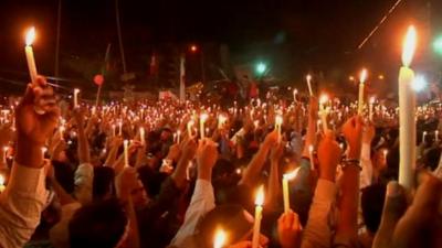 Protesters in Dhaka holding candles