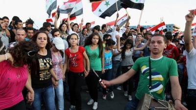 Pro-regime Syrians at a rally in Damascus