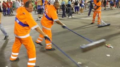 Cleaners sweeping the streets after the Rio carnival