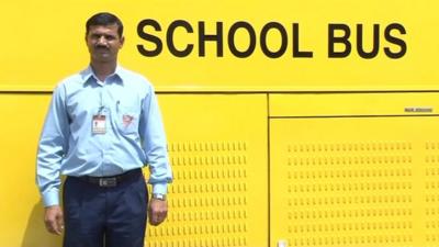 Gyanendra Singh in front of his school bus